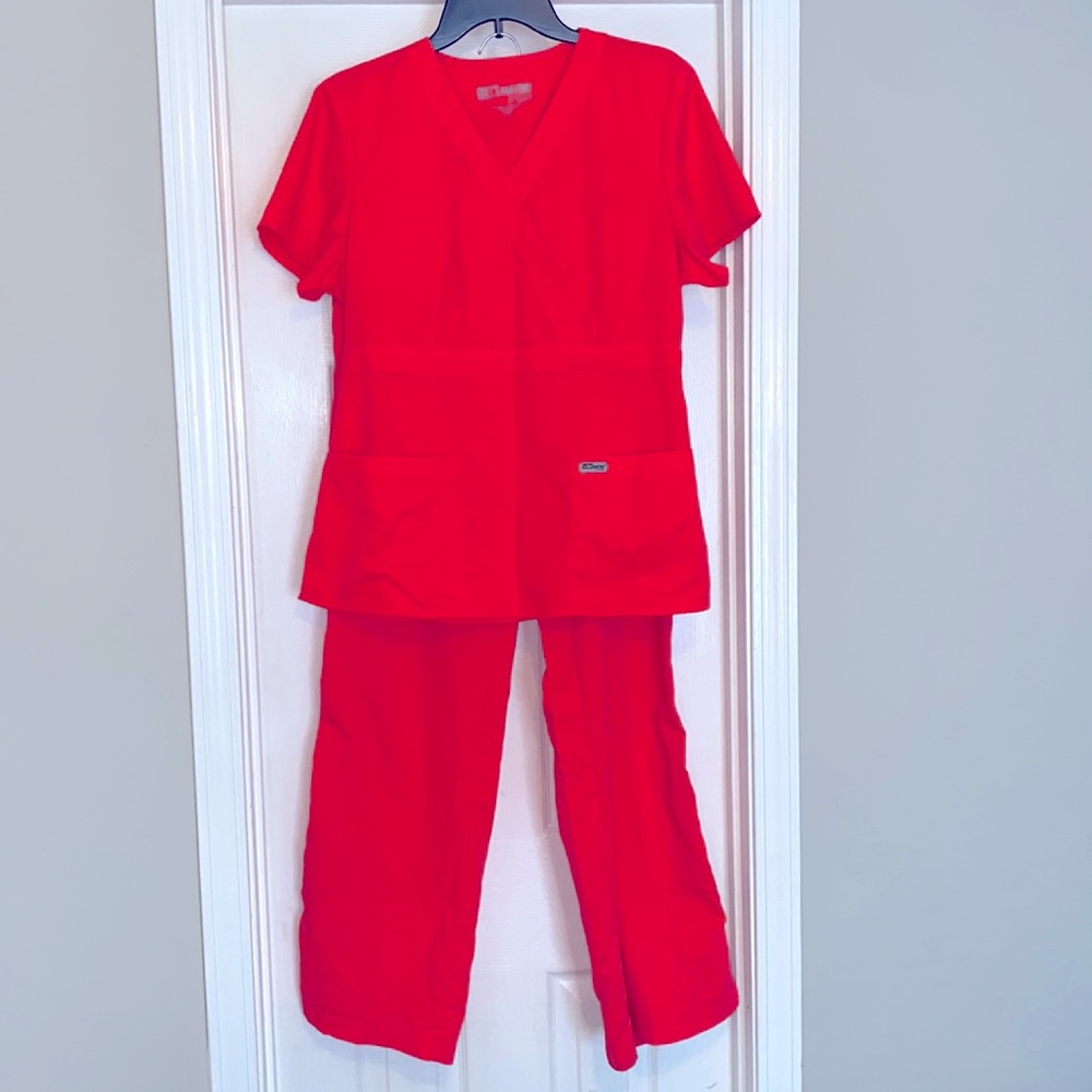 Scrub set: Grey’s Anatomy women’s bright neon pinkish orange. L top M bottom